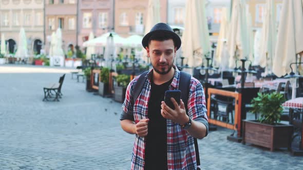 Tourist Making Video Call on Smartphone and Showing His Place of Visit