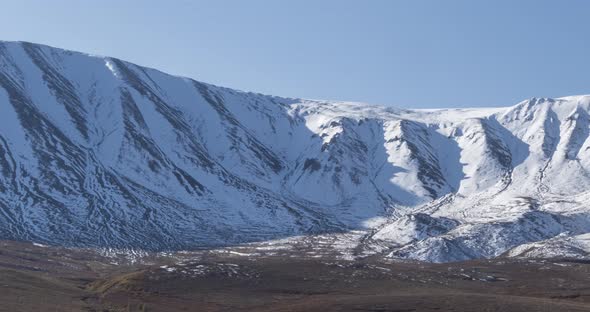 Timelapse of Sun Movement on Crystal Clear Sky Over Snow Mountain Top