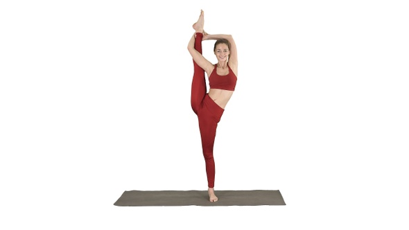 Female Yoga Model Making Standing Split Smiling on White