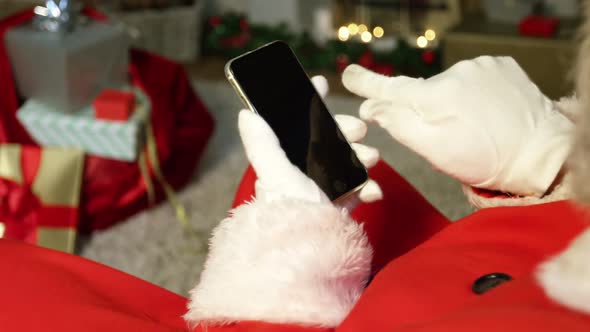 Close-up of santa claus using mobile phone