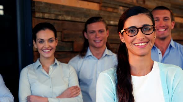 Business executives standing with arms crossed in office