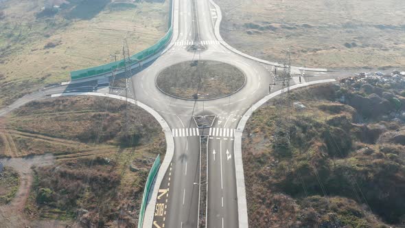 New empty four-lane road through desolate rural countryside, with clear surface marking of lanes