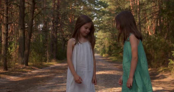 Two Beautiful Girls Walking in the Woods