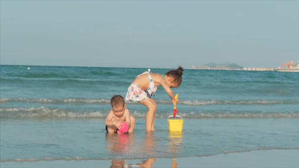 Happy and Carefree Children Playing By the Sea with Sand. Children Playing, Brother and Sister Play