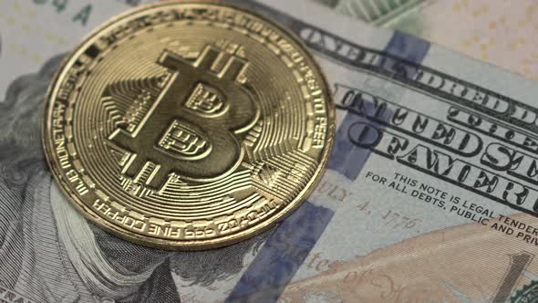 Bitcoin Golden Coin on 100 Dollar Banknote, Close Up. Cryptocurrency Concept