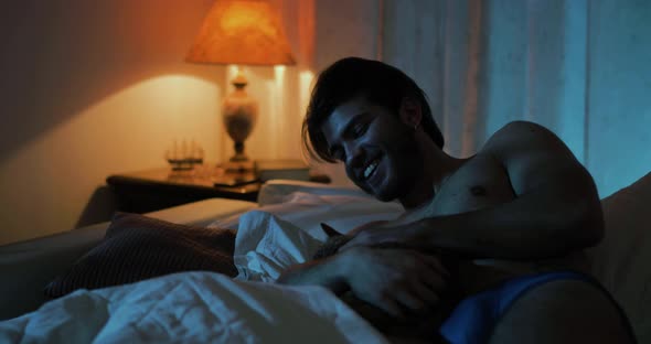 Boy Playing with cat on the Bed