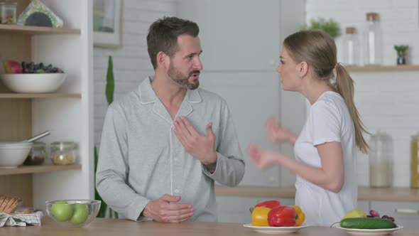 Young Woman Arguing with Man in Kitchen