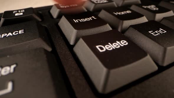 Trembling Person Hand Presses Insert Button at Control Keys