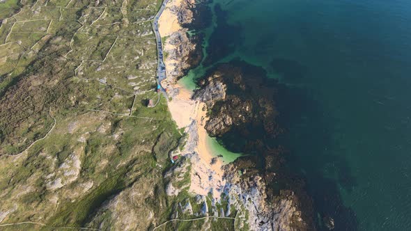 Top-down Shot Of Turquoise Blue Sea And Rocky Coast At The Coral Strand Beach In Connemara, Ireland