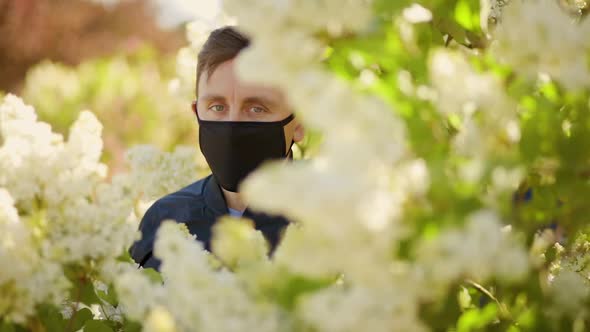 Man in Black Face Mask Looks Away During Virus Pandemic