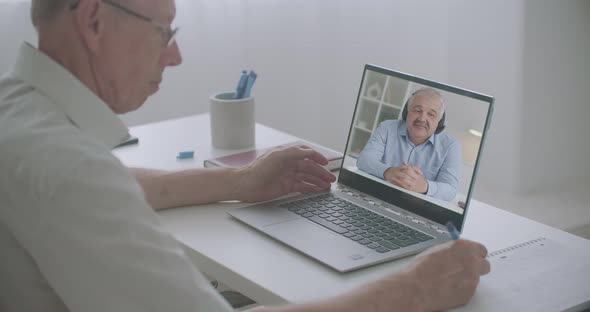 Modern Technology of Learning and Education By Internet, Elderly Man Is Listening and Viewing