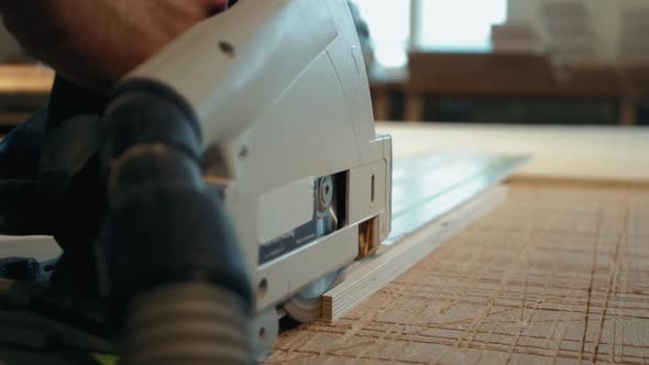 Close Up of Carpenter's Hands Cutting Wood with Table Saw in Workshop, Craftsman Furniture