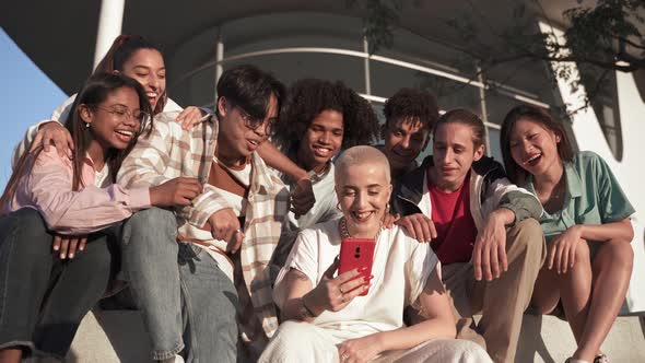 Group of Happy Teenager Friends Having Fun Sharing Funny Social Media Moments on a Mobile Phone App
