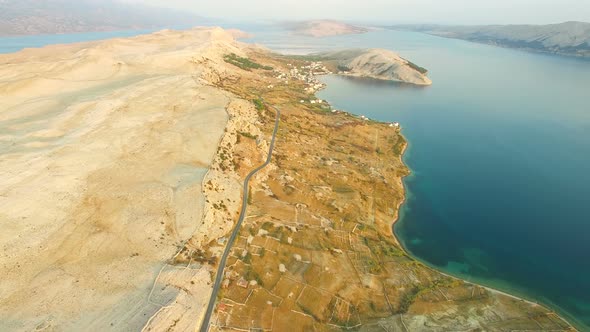 Flying above desert island of Pag at sunset, Croatia