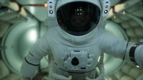 Astronaut Inside the Orbital Space Station alt