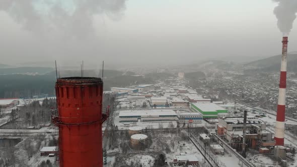 Red and White Smoking Pipes in Industrial Zone