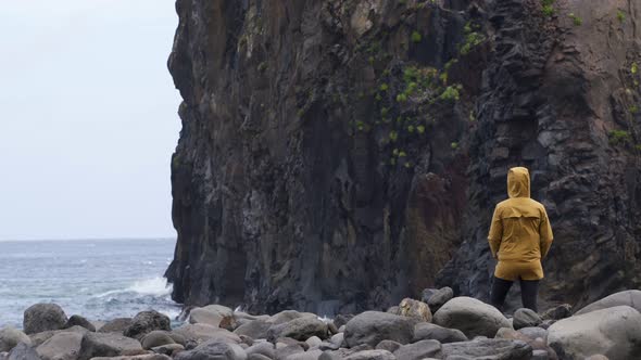 Woman looking at Ribeira da Janela islet in Madeira