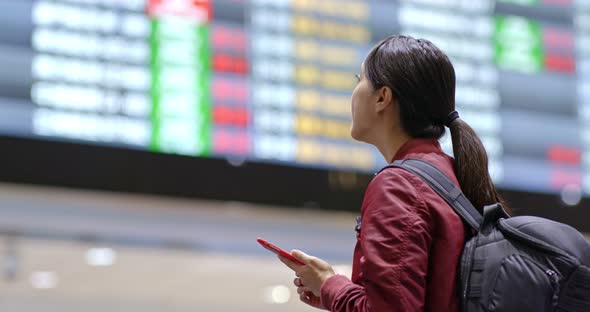 Woman check the flight number in the airport