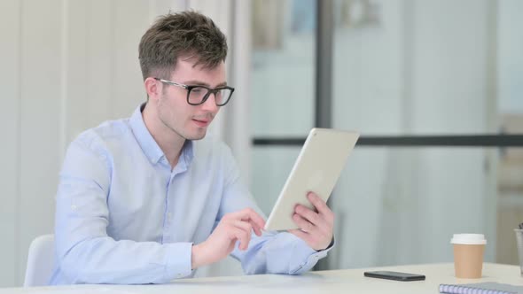 Successful Young Man Celebrating on Tablet