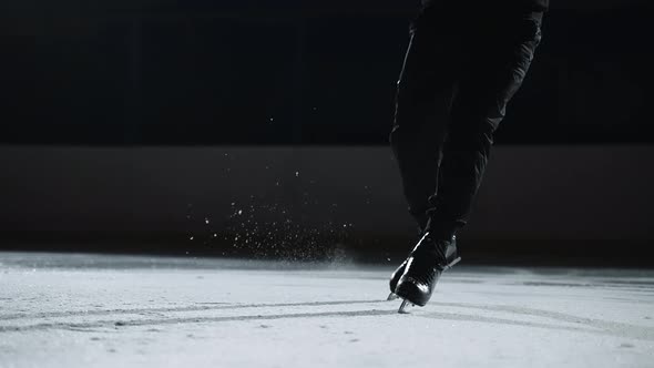 Male Figure Skater is Training or Performing Program on Competition Closeup View on Feet Shod Skates