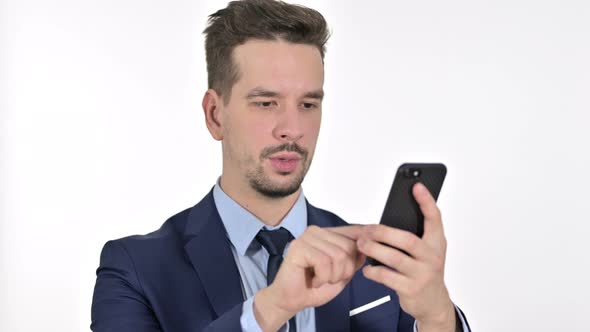 Portrait of Cheerful Young Businessman Using Smartphone, White Background