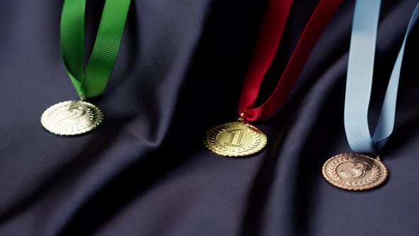 Gold Silver and Bronze Medals with Ribbons on Black Background Closeup