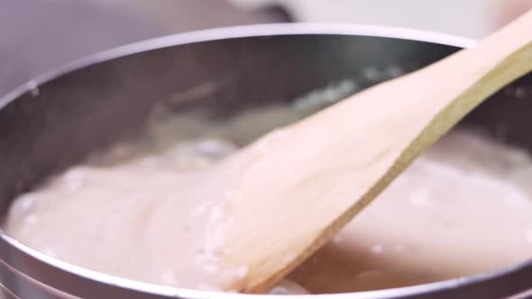 Homemade mushroom carbonara sauce in a pot on the electric stove in the kitchen.