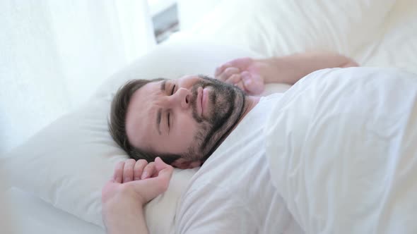 Attractive Beard Young Man Waking Up and Getting Out of Bed 