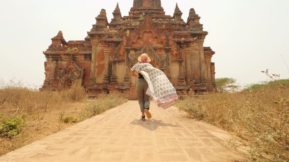 Young Tourist Woman Running in White Dress To Old Traditional Burmese Temple. Travel Adventure