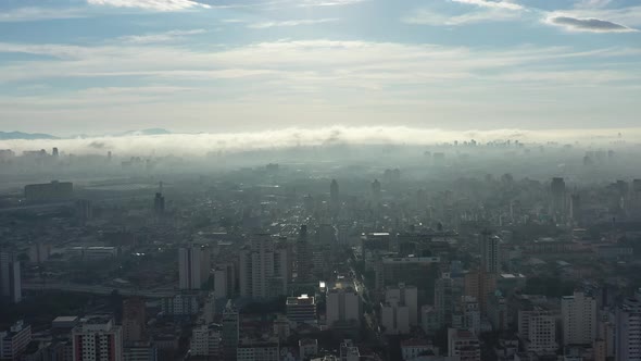 Fog morning at downtown district. Above the clouds.