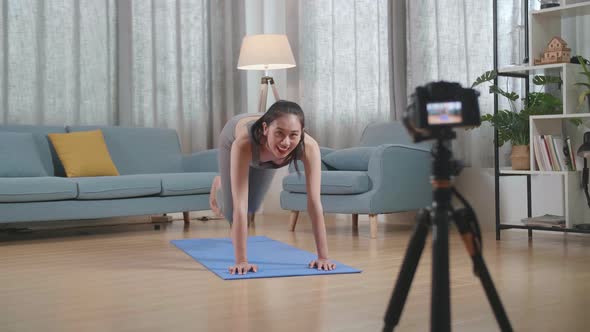 Trainer Female Speaking To Camera Before Doing Cardio High Knees And Core Strengthening Exercises