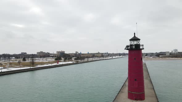 Aerial view of lighthouse and long pier in Wisconsin in winter. alt