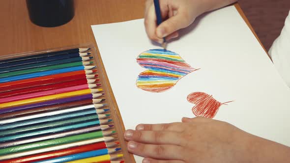 Children's Hands Will Paint a Big Heart in Rainbow Colors