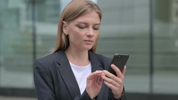 Young Businesswoman Using Smartphone Outdoor