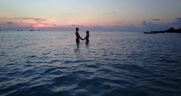 Fun couple in love dating on vacation enjoy luxury on beach on paradise white sand 4K background