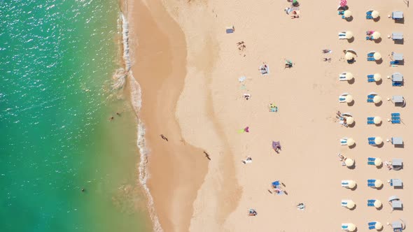 Aerial View of the People Swimming and Getting a Tan on the Beach