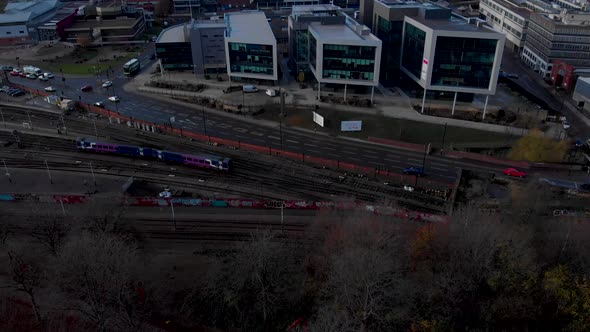 Drone shot above the city of Sheffield, panning over the Train Station, Sheffield Hallam, Park Hill