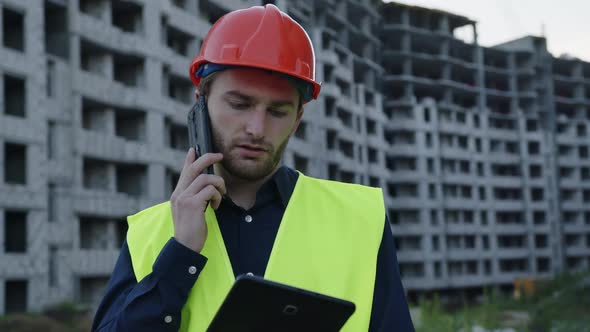 Close Up View of Young Worker Who Talks on Phone