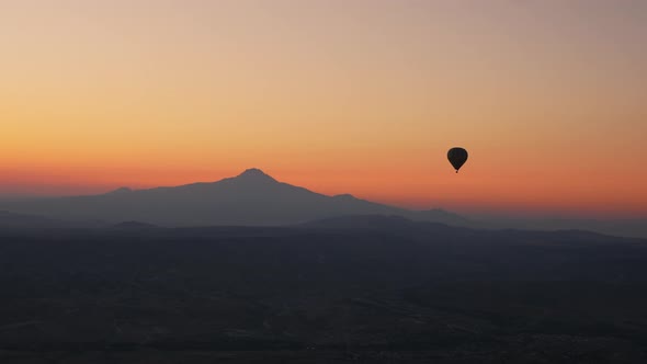 Silhouette of a Hot Air Balloon Flying in the Sky After Sunset