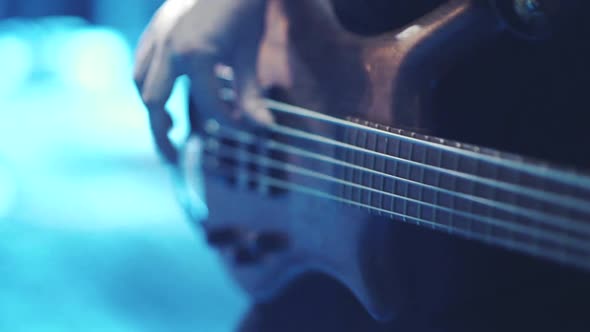 Man Bass Guitarist Playing Electrical Guitar on Concert Stage