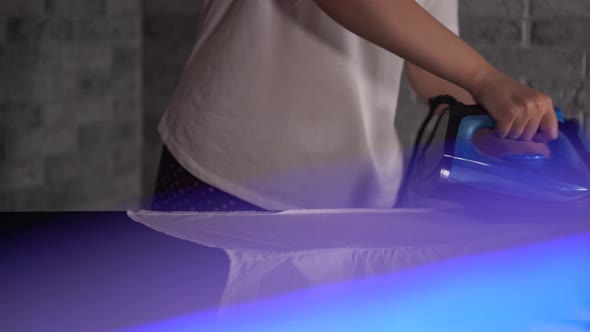 Woman Ironing Clothes on Ironing Board Closeup