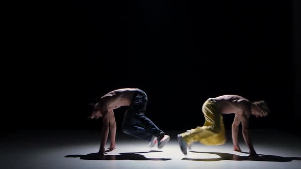 Two Breakdance Dancers with Naked Torso Starts Dance, on Black, Shadow