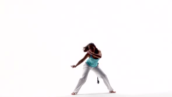 Energetic Girls Are Practicing Capoeira in White Background of Studio. Afro-Brazilian Martial Art