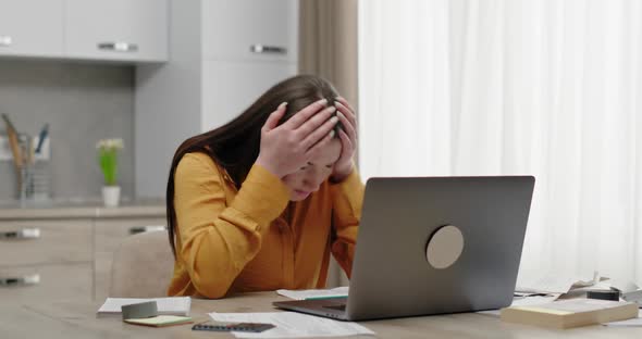 Woman Working at Home Office Looks Surprised at Laptop Feels Defeated Indignation and Sadness Shame