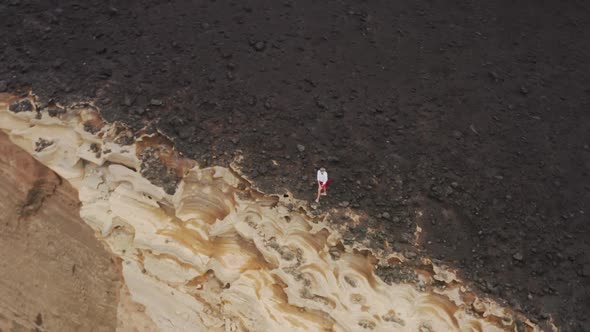 Aerial Footage of a Tourist Exploring the Island Washed By Bluish Waters