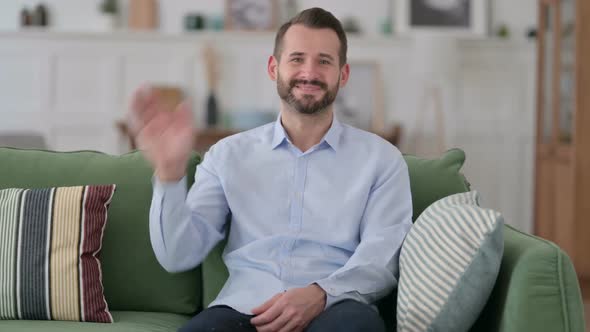 Hello By Welcoming Young Man Waving at Camera