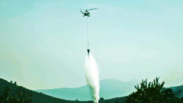 Helicopter flying to put out forest fire