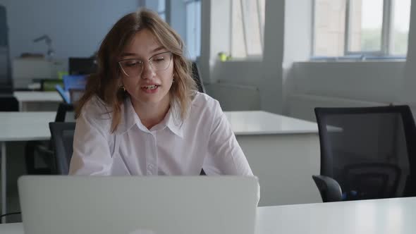 Close Up Young Lady Chat Online in an Office