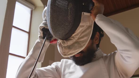 Fencer athlete during a fencing training in a gym