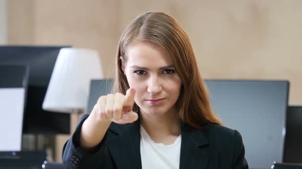 Woman in Office Pointing at Camera, Portrait